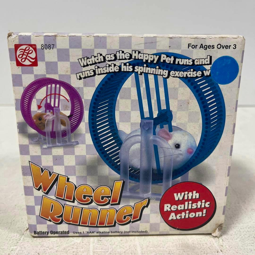 Front of the Wheel Runner box showing the toy's plastic exercise wheel and a small hamster illustration.
