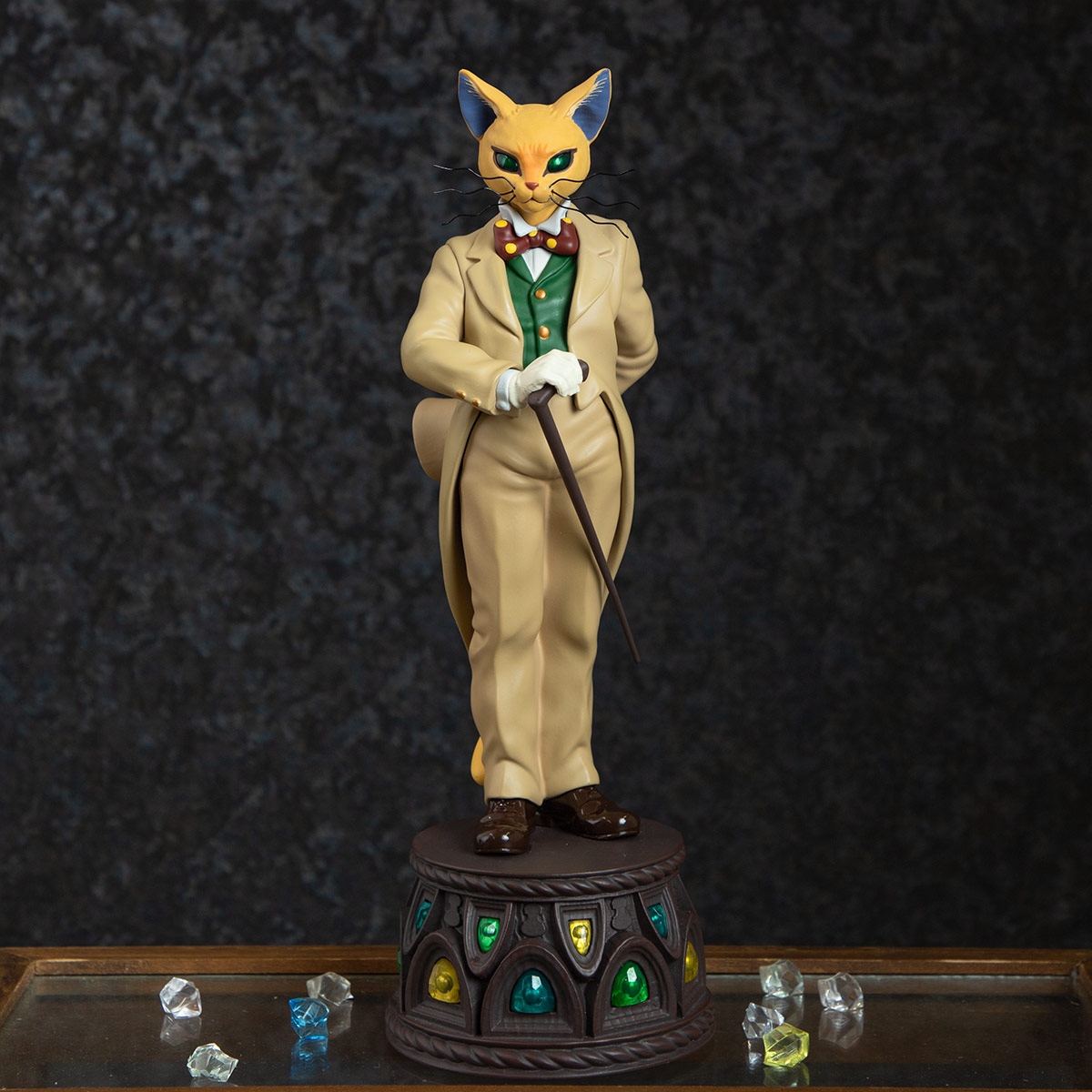 Front view of the music box featuring a cat figurine in a cream suit standing on a decorative round base.