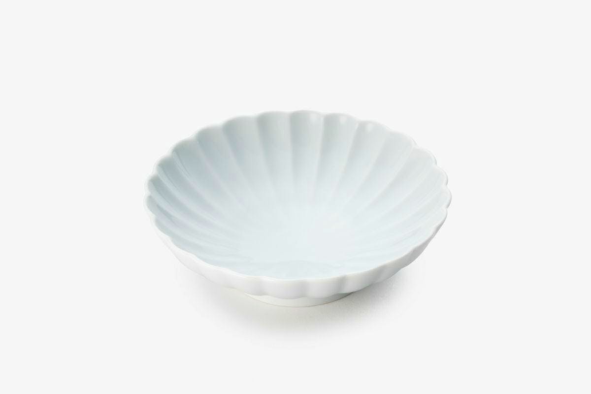 White porcelain chrysanthemum-shaped small bowl photographed on a white background.