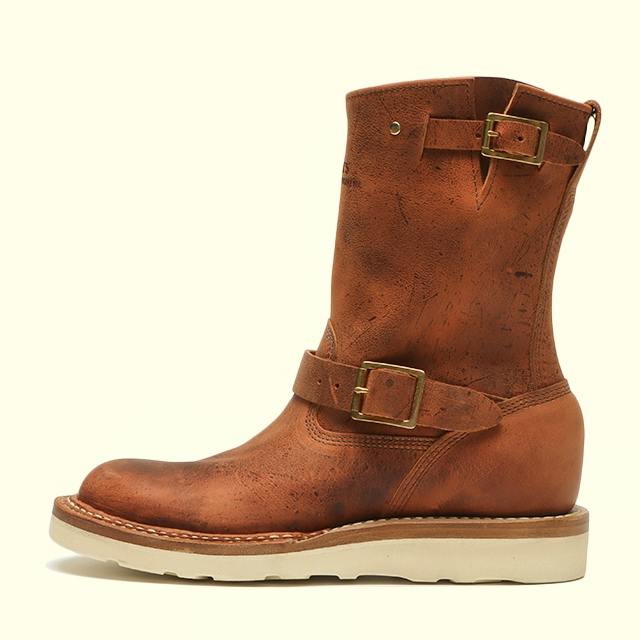 Profile view of a WHITE'S 10-inch Nomad Takami brown leather boot with two buckles and a white wedge sole.