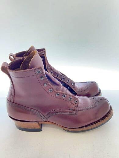 Side view of a pair of leather lace-up boots showing the outer profile and stacked heel.