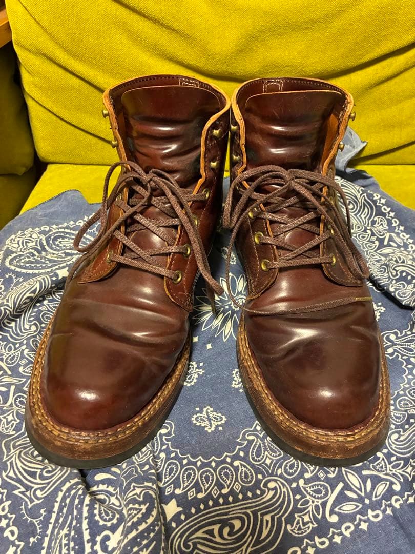 Front view of White's Boots brown leather boots placed on a patterned cloth.