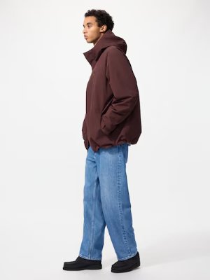Person shown in profile wearing light blue wide straight jeans.