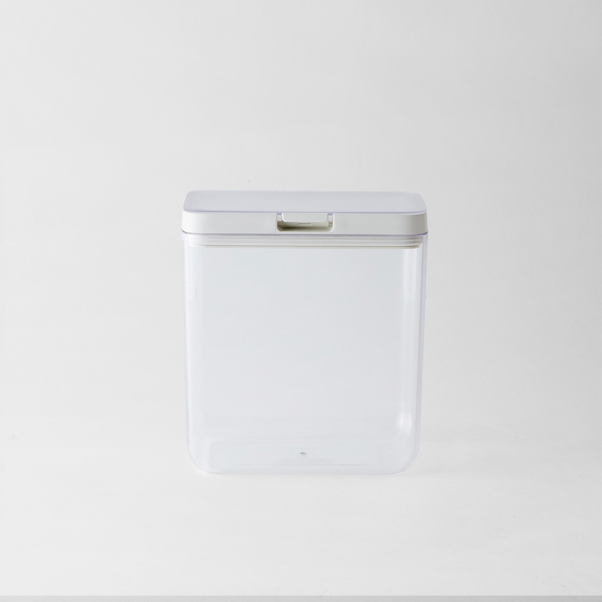 Front view of a clear plastic storage container with a white lid on a plain background.
