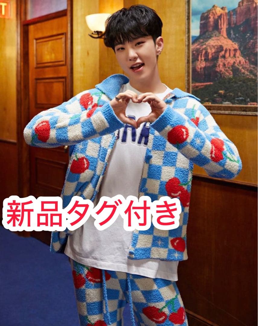 Male model wearing the men's polyester long-sleeve pajama set with blue-and-white check and red cherry print, standing indoors.