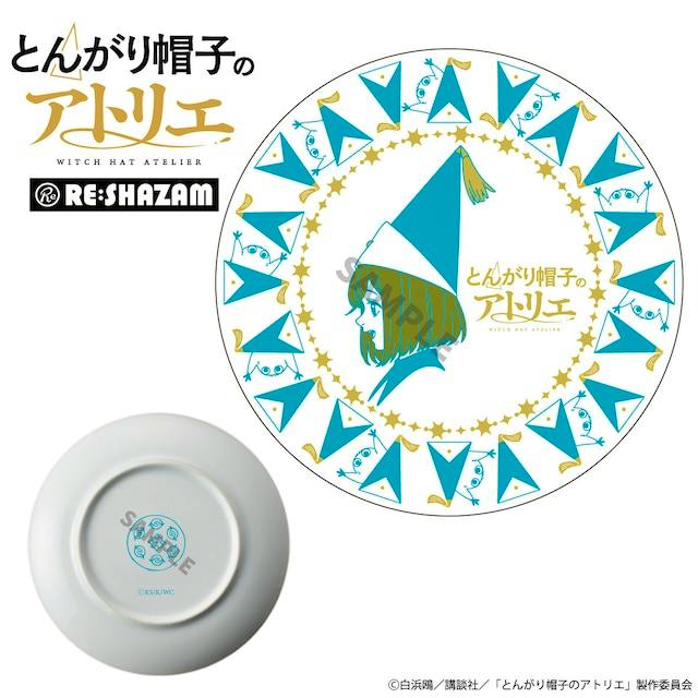 Round ceramic plate featuring an illustrated girl wearing a pointed hat, surrounded by blue triangular-hat characters and gold star accents.