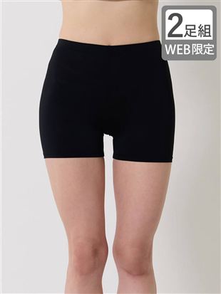 Front view of a model wearing black, short-length nylon-blend women's leggings.