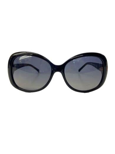 Front view of the black plastic women's sunglasses showing large rounded tinted lenses and frame.