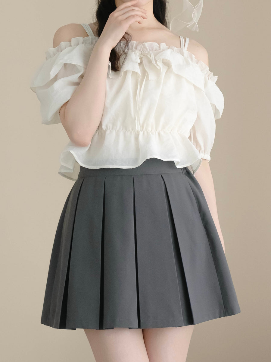 Model wearing a dark grey box-pleated women's skirt (polyester), shown from waist to mid-thigh.