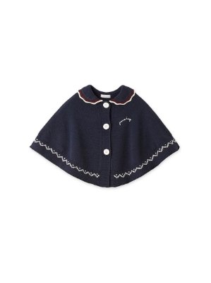 Studio image of a navy collared knit poncho (women's cape) with front buttons and white decorative trim on a white background.