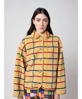 Front view of a model wearing the color striped sheepskin jacket with a collar and button closure.