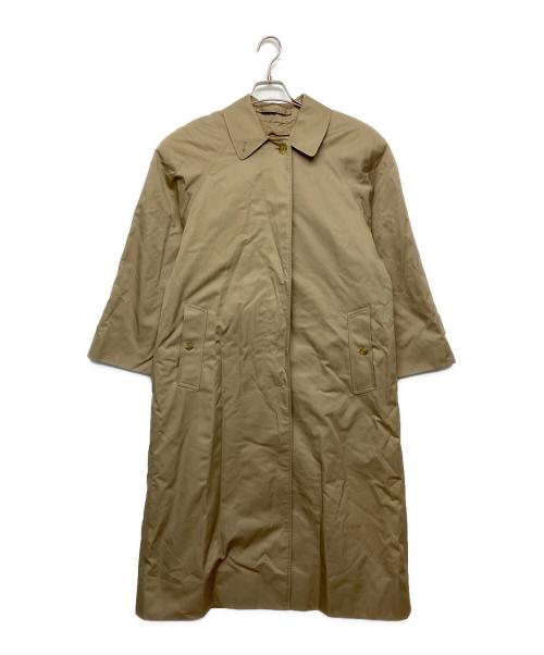 Beige ステンカラーコート (women's cotton jacket) hanging on a hanger against a white background.