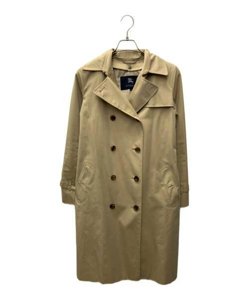 Beige women's long cotton coat hanging on a hanger, front view showing double-breasted buttons.
