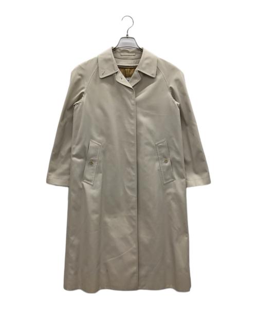Light beige women's stand-collar coat with a liner hanging on a hanger against a white background.