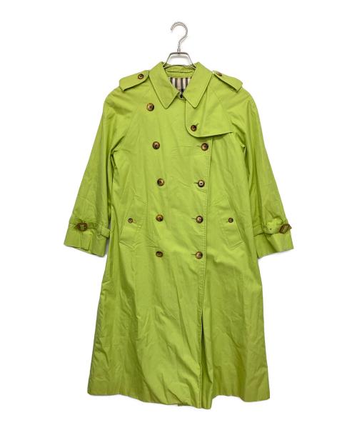 A women's cotton trench coat in bright green displayed on a hanger against a white background.