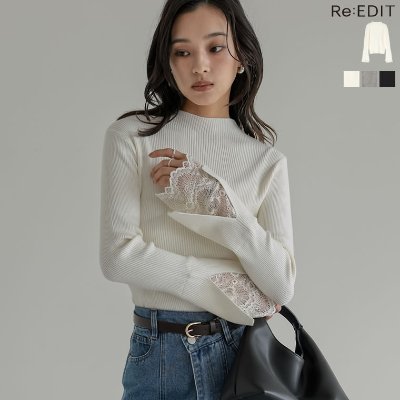 Model wearing a white ribbed high-neck knit top with lace-trimmed flared sleeves, styled with jeans and a black bag.