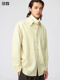 A model wearing the drape shirt in a light cream color, shown from the front.