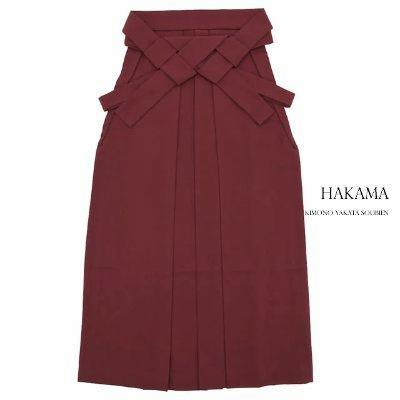 A maroon women's hakama displayed flat on a white background.