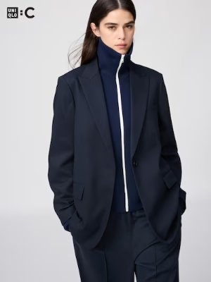 Model wearing the women's tailored jacket over a zip-up top.