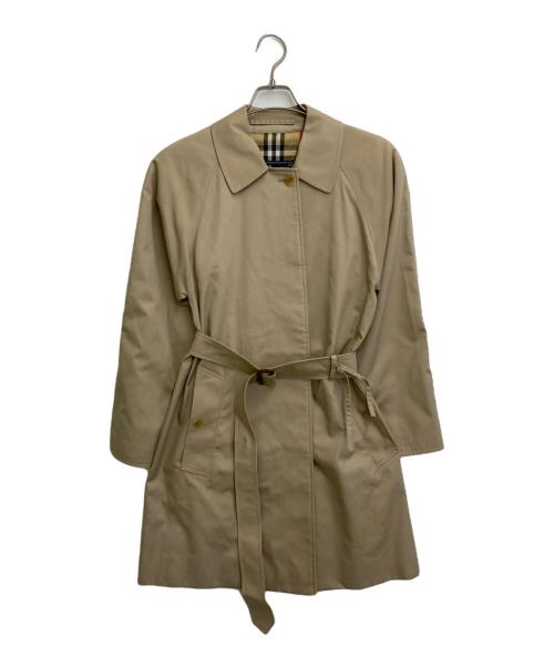 Beige raglan stone-collar women's cotton coat hung on a hanger against a white background.