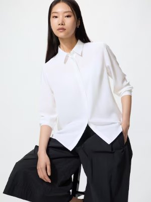 Model wearing a white women's rayon blouse with a collar and three-quarter sleeves.