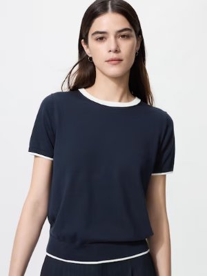 Woman wearing a navy UV-cut crew neck sweater with white trim.