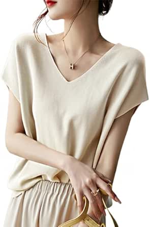 Woman wearing a cream short-sleeve V-neck knit sweater.