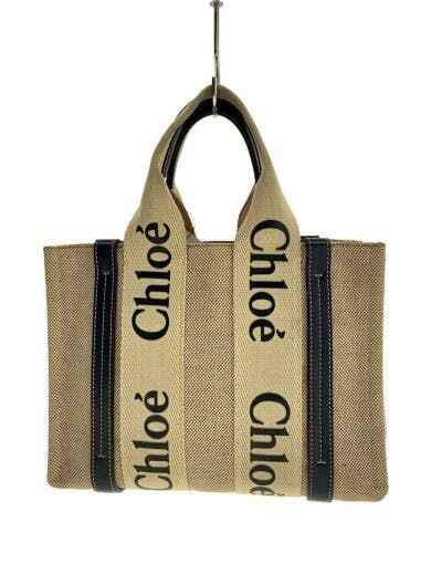 Beige canvas small tote bag with wide straps printed "Chloé" shown hanging from a hook.