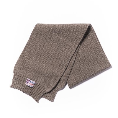 A folded brown wool-knit scarf on a white background with a small woven label near one end.