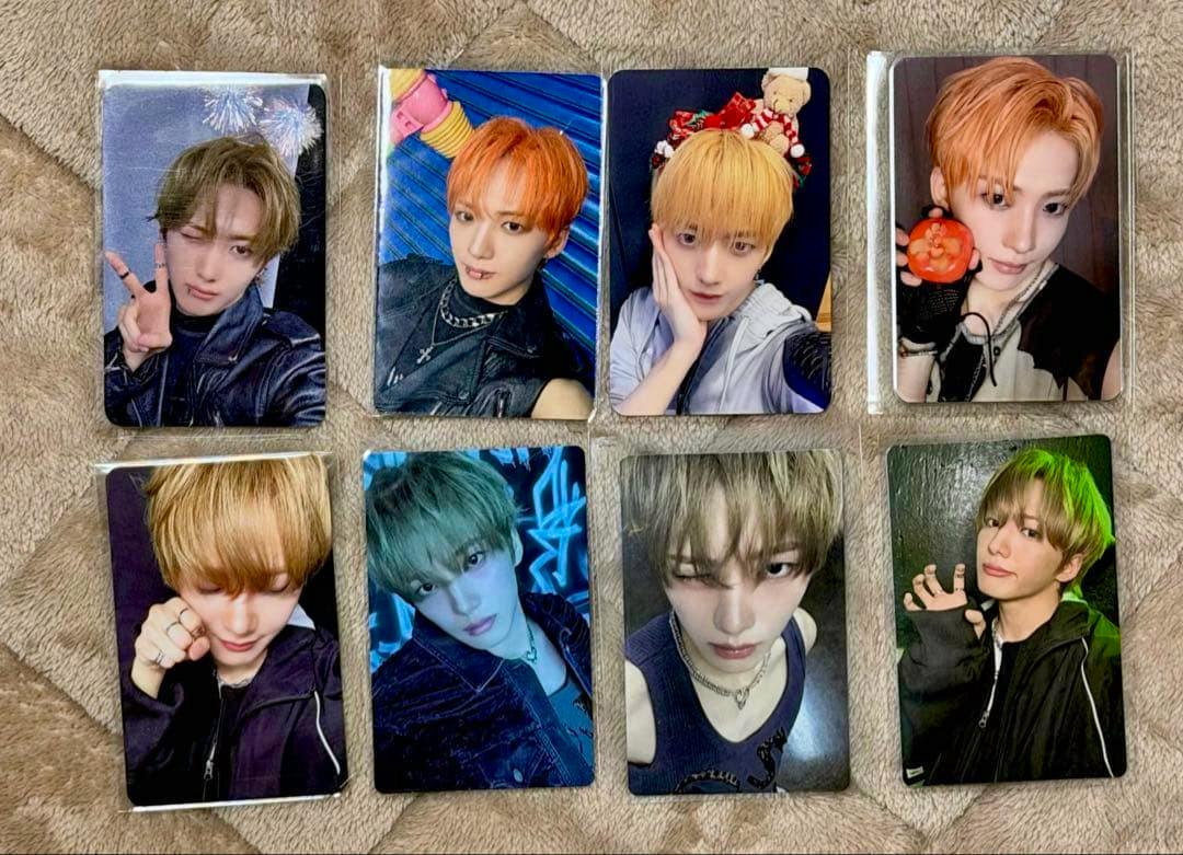 Eight Minje photocards from xikers arranged on a blanket.