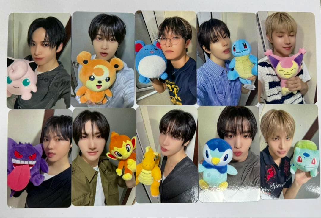 Photocards laid out on a white background showing portrait photos of people holding plush toys.