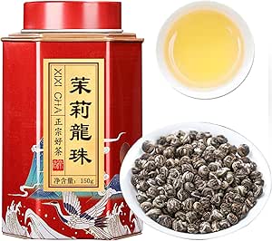 A red decorative tin next to a bowl of rolled jasmine dragon pearl tea leaves and a cup of brewed jasmine tea.