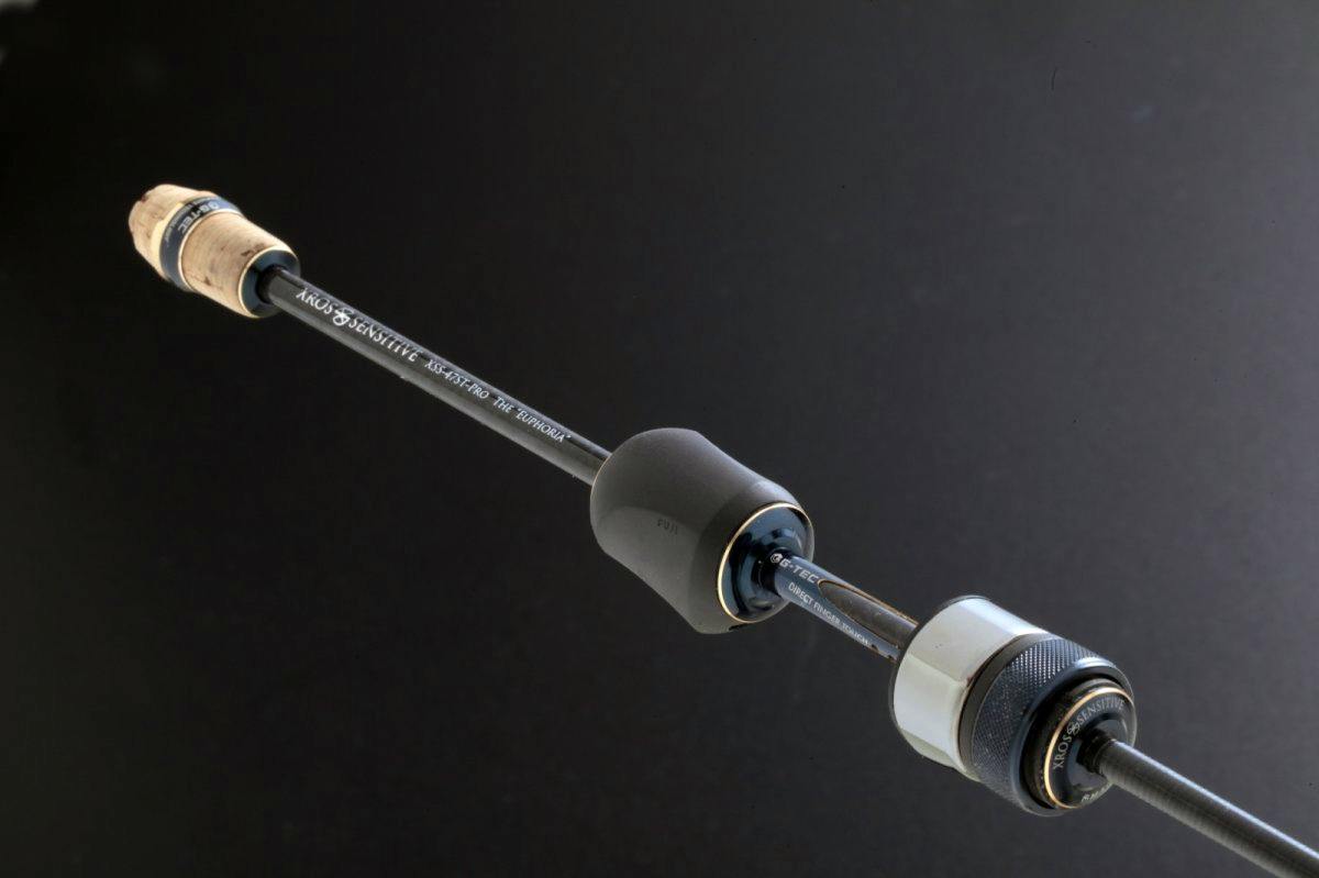 Close-up of the XrosSensitive XSS-47ST-Pro "The EUPHORIA" fishing rod handle and shaft against a dark background.