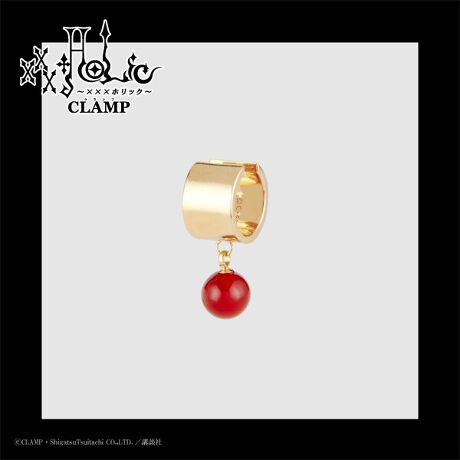 Product photo of the xxxHOLiC ear cuff showing the cuff with a single dangling red bead against a plain background.