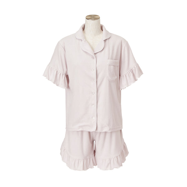 Lavender women's pile pyjamas set with a short-sleeve button-up top and matching ruffled shorts displayed on a mannequin.