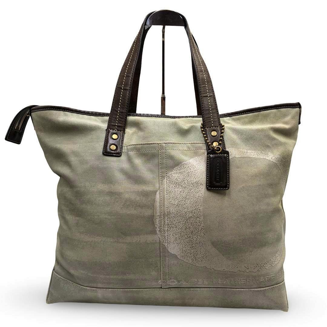 Front view of the y2k COACH 2way shoulder tote bag with dual leather handles and a large faded circle logo on the fabric.