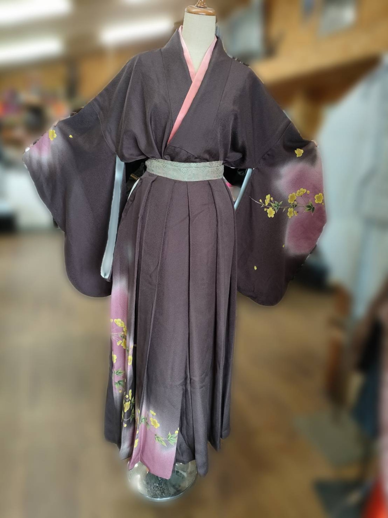 A women's polyester Yabusame kimono costume in brown with pink accents displayed on a mannequin.