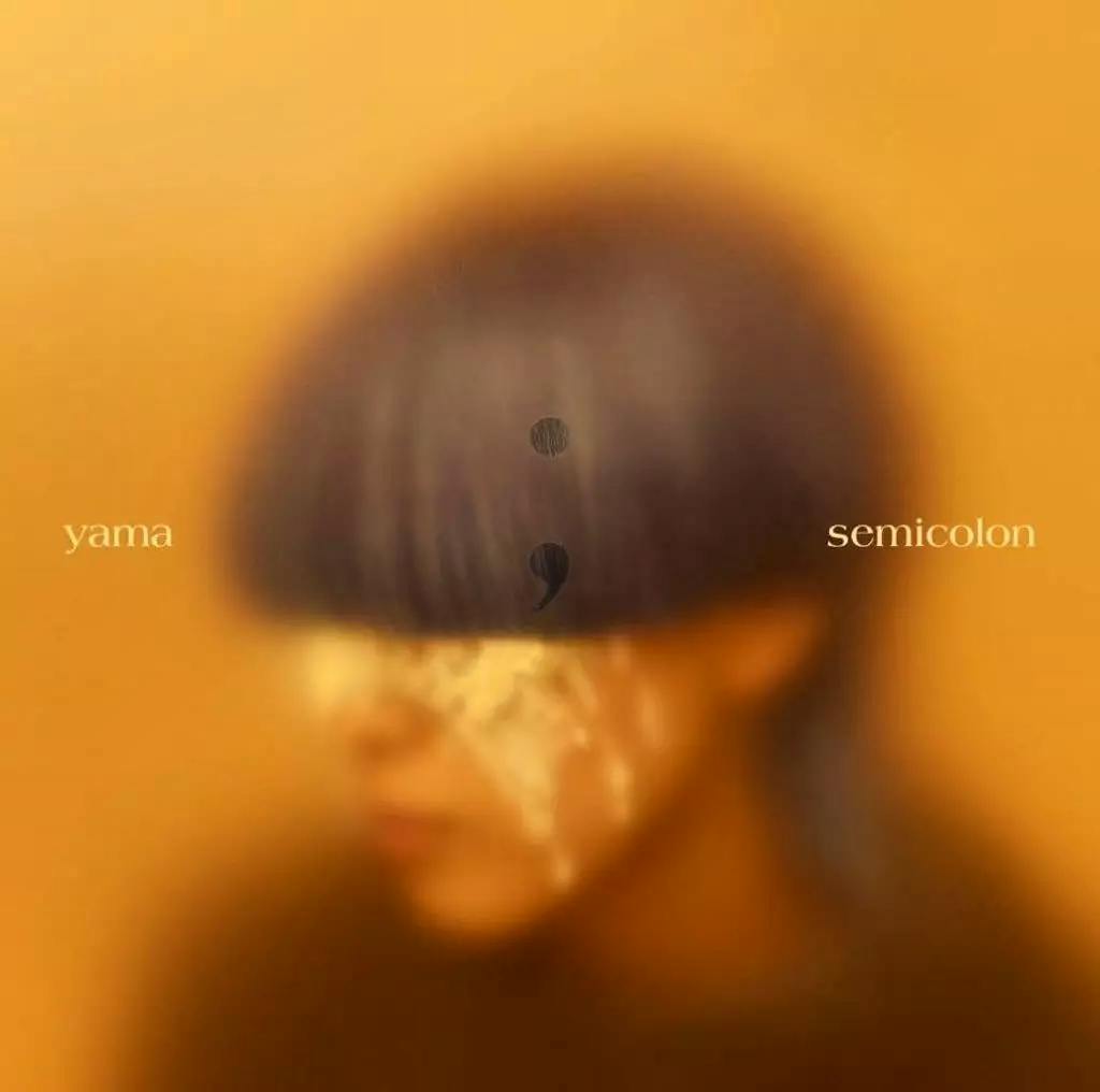 Blurred orange-toned album cover showing a close-up portrait, a semicolon symbol, and the words "yama" and "semicolon".