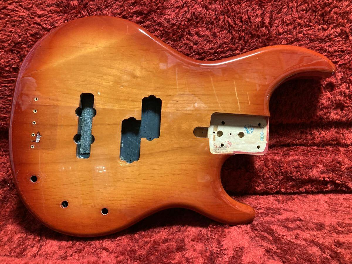 Used Yamaha RBS50 4-string bass guitar body showing pickup cavities, control holes, and neck pocket on a red plush background.