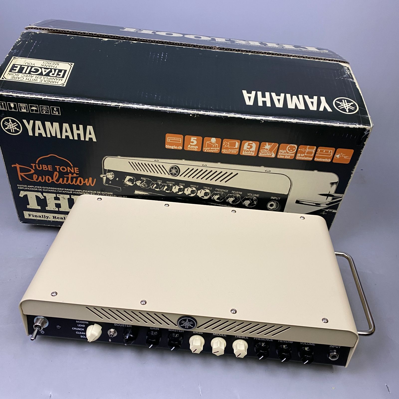Top-front view of a Yamaha THR100H amplifier placed in front of its original Yamaha product box.