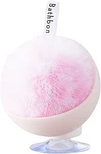 Pink pom-pom bath sponge seated in a round white case with a suction-cup base and a hanging loop.