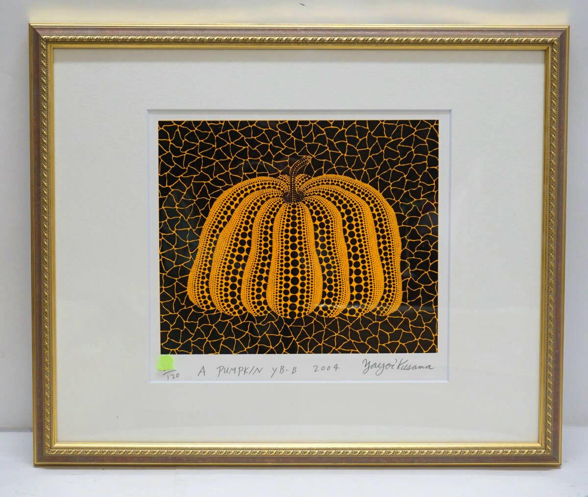 Framed silkscreen print titled “A PUMPKIN” showing an orange dotted pumpkin on a black patterned background in a gold frame.