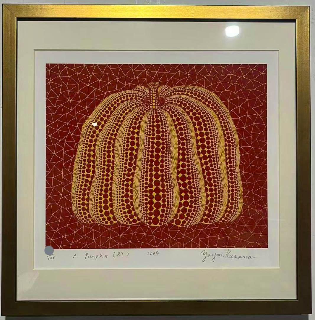 Framed silkscreen print titled "A Pumpkin (RY)" (2004) by Yayoi Kusama showing a red and yellow dotted pumpkin, matted and in a gold frame.