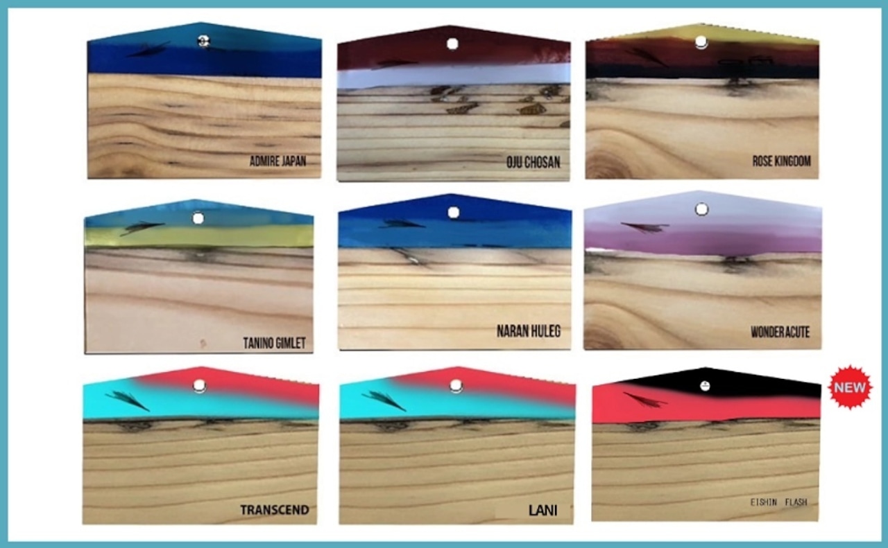 A 3x3 grid photo showing nine wooden ornament (絵馬) plaques with different colored tops and printed names.