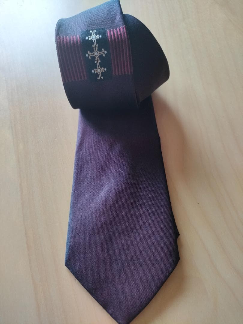 Bordeaux silk necktie (Yohji Yamamoto) laid flat showing the full front and patterned tail.