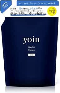 A dark blue refill pouch labeled "yoin Silky Veil Shampoo."