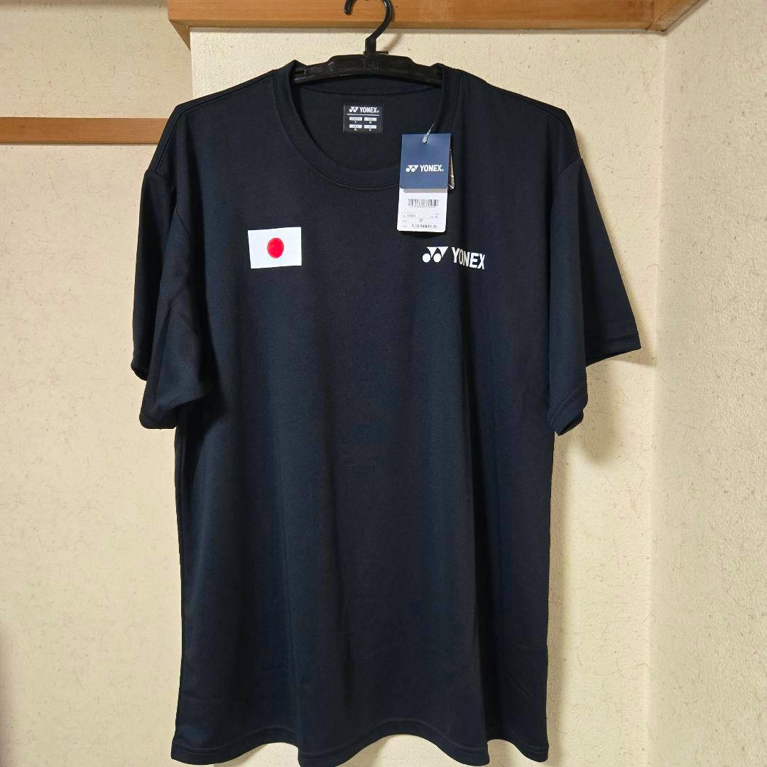 Front of a black Yonex Japan badminton practice/game shirt with a small Japanese flag and Yonex logo hanging on a hanger.
