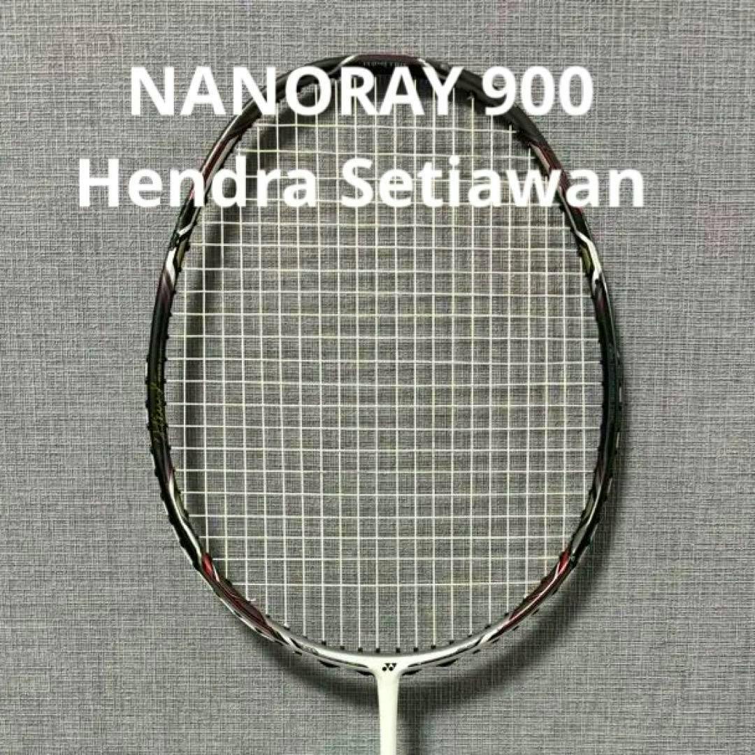 A Yonex Nanoray 900 badminton racket head and strings shown against a gray textured background.
