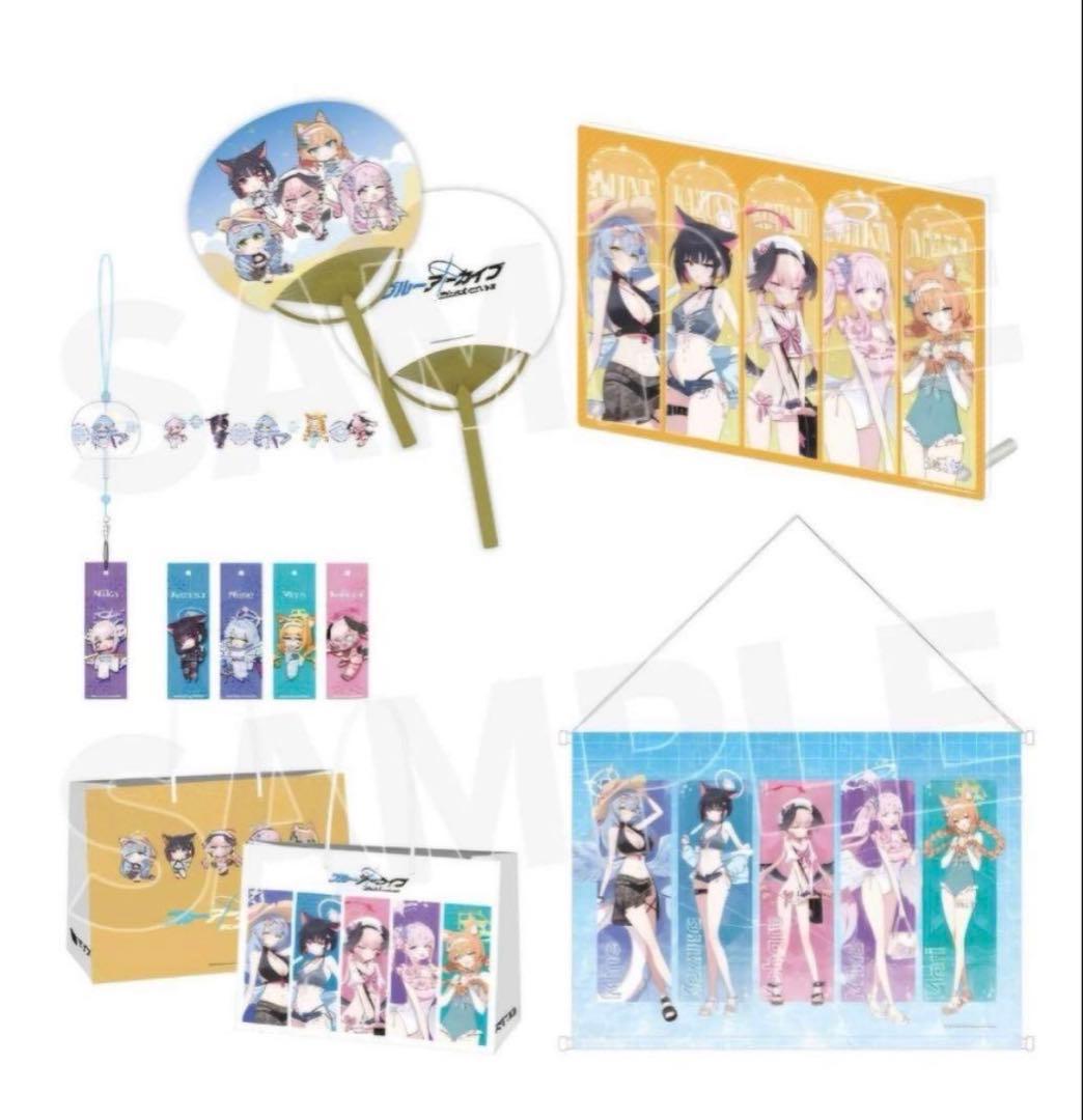 Mockup image showing the C108 Yostar Trinity Academy swimsuit goods set with fans, bookmarks, a box, and a hanging tapestry featuring the characters.