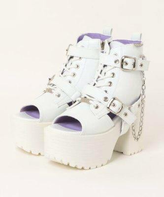 White platform lace-up boot sandals with peep toes, buckles and a decorative chain.